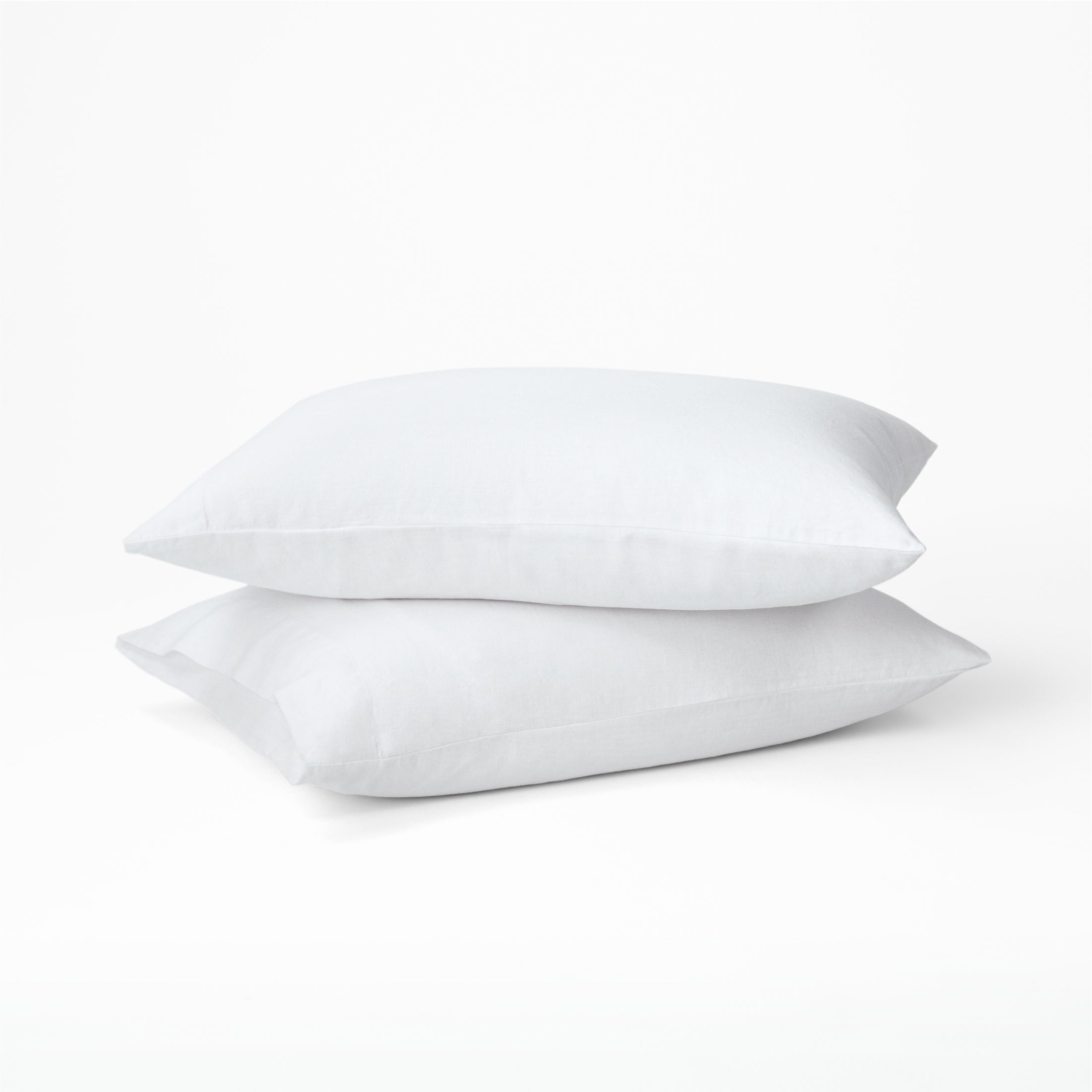 Two pillows dressed in the Tuft and Needle Hemp Pillowcase Set||color:cloud