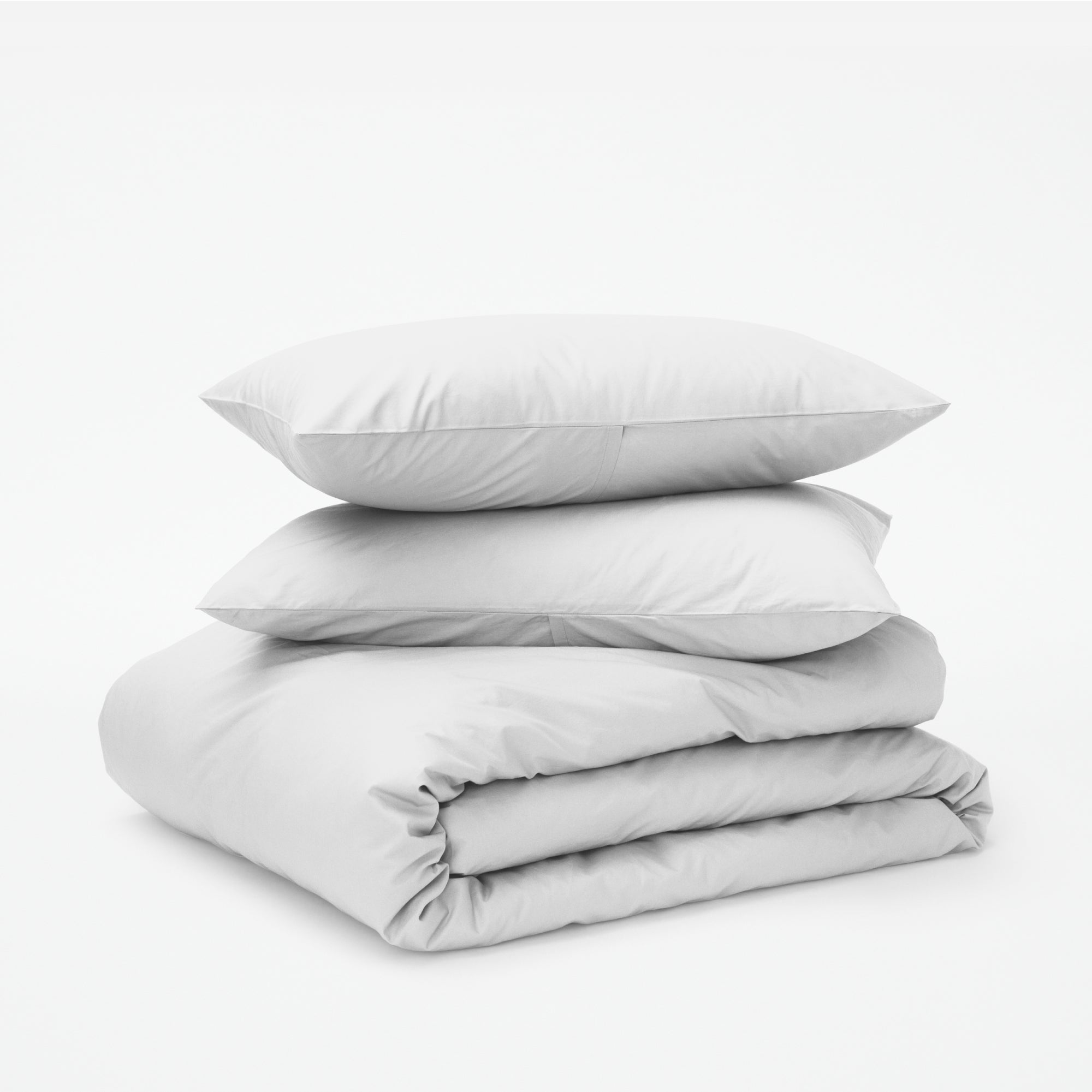 The Tuft and Needle Classic Percale Duvet Set, two pillows stacked on top of a sheet set || color: Cloud