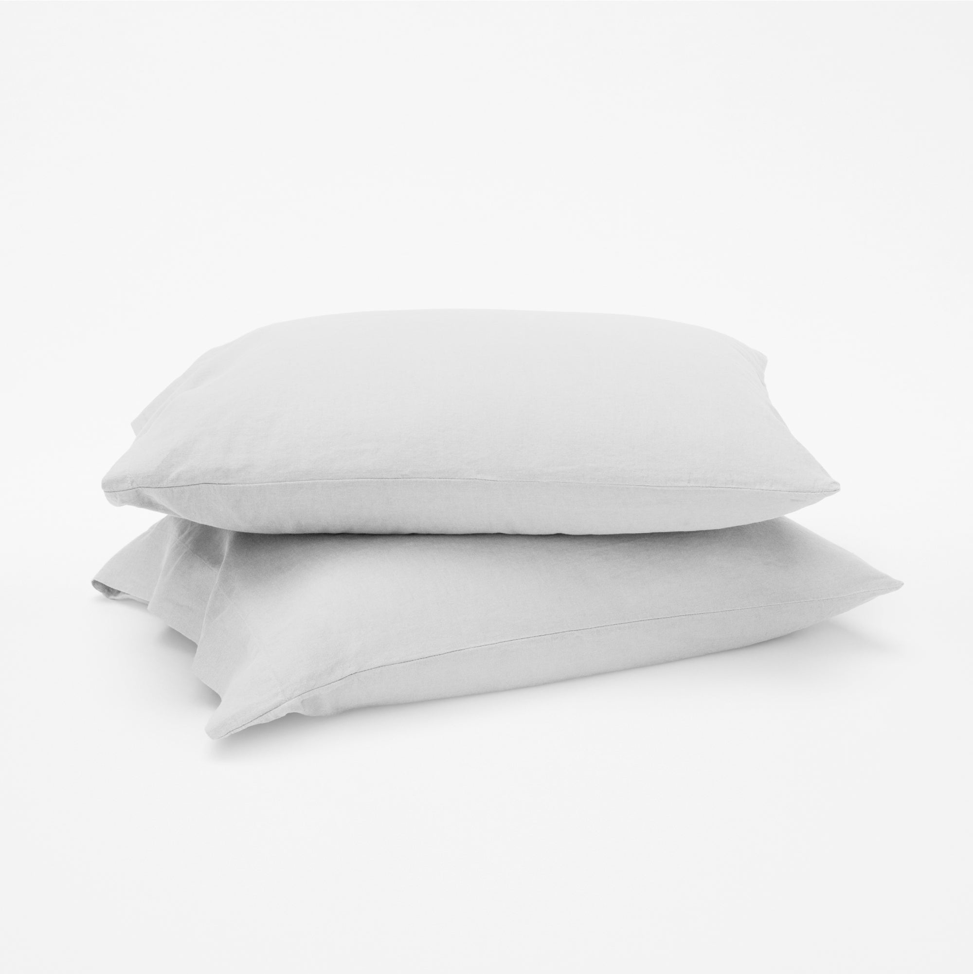 The Tuft and Needle Linen-Cotton Blend Pillowcase Set, 2 pillows in a pillowcase stacked on top of each other || color: Cloud