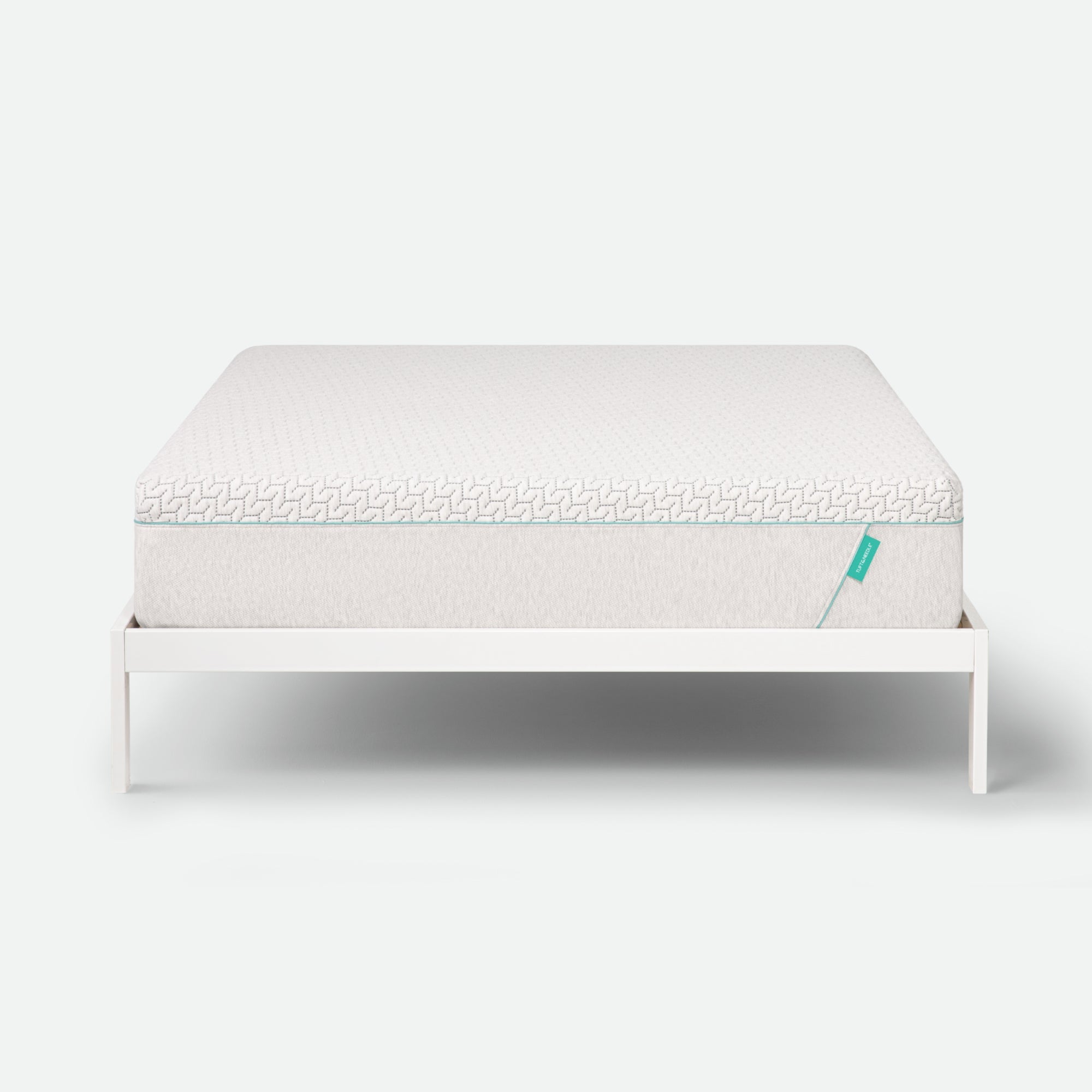Tuft & Needle Mattress on a white stand with a white background