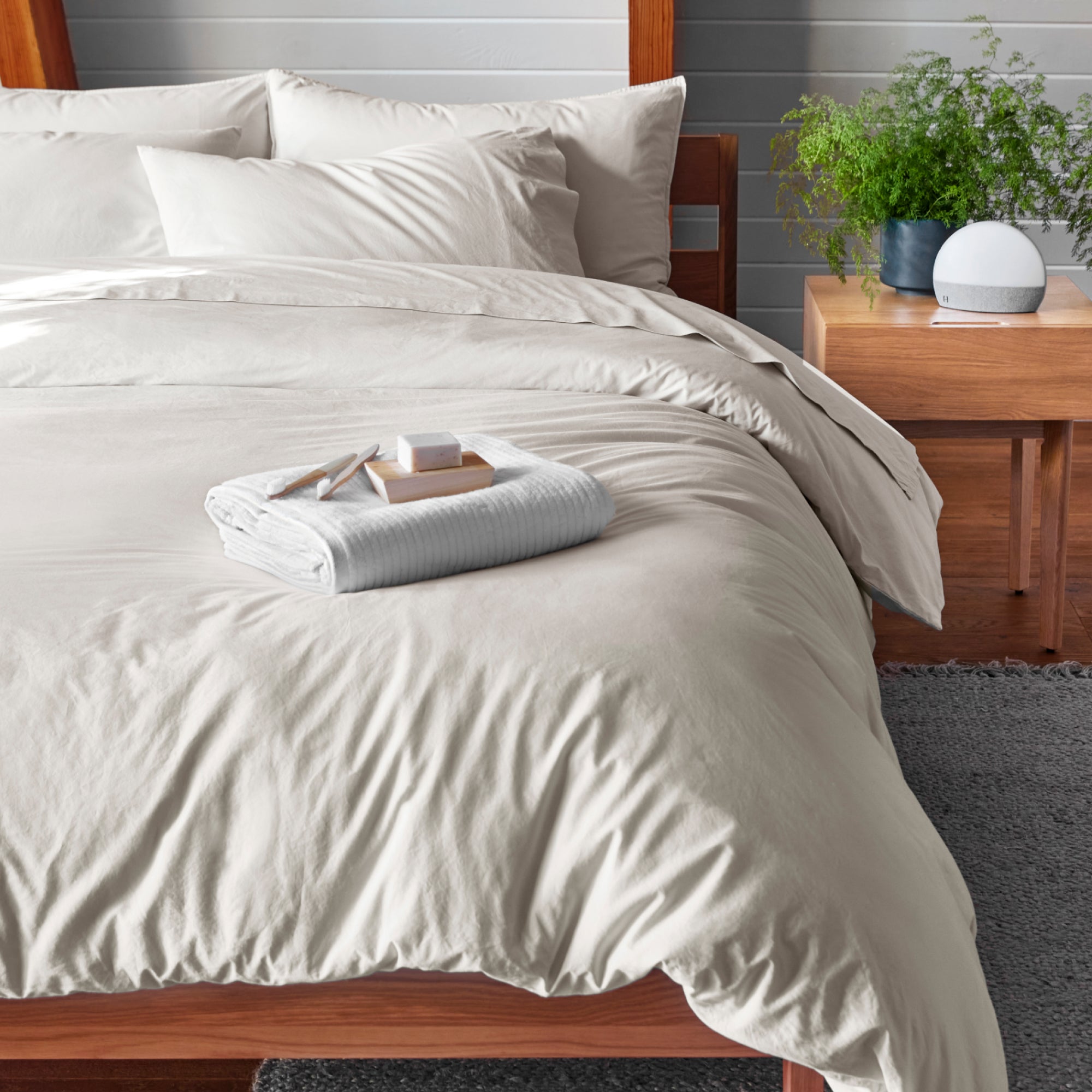 The Tuft and Needle Percale Duvet Cover Set on a mattress in a bedroom||color:sand